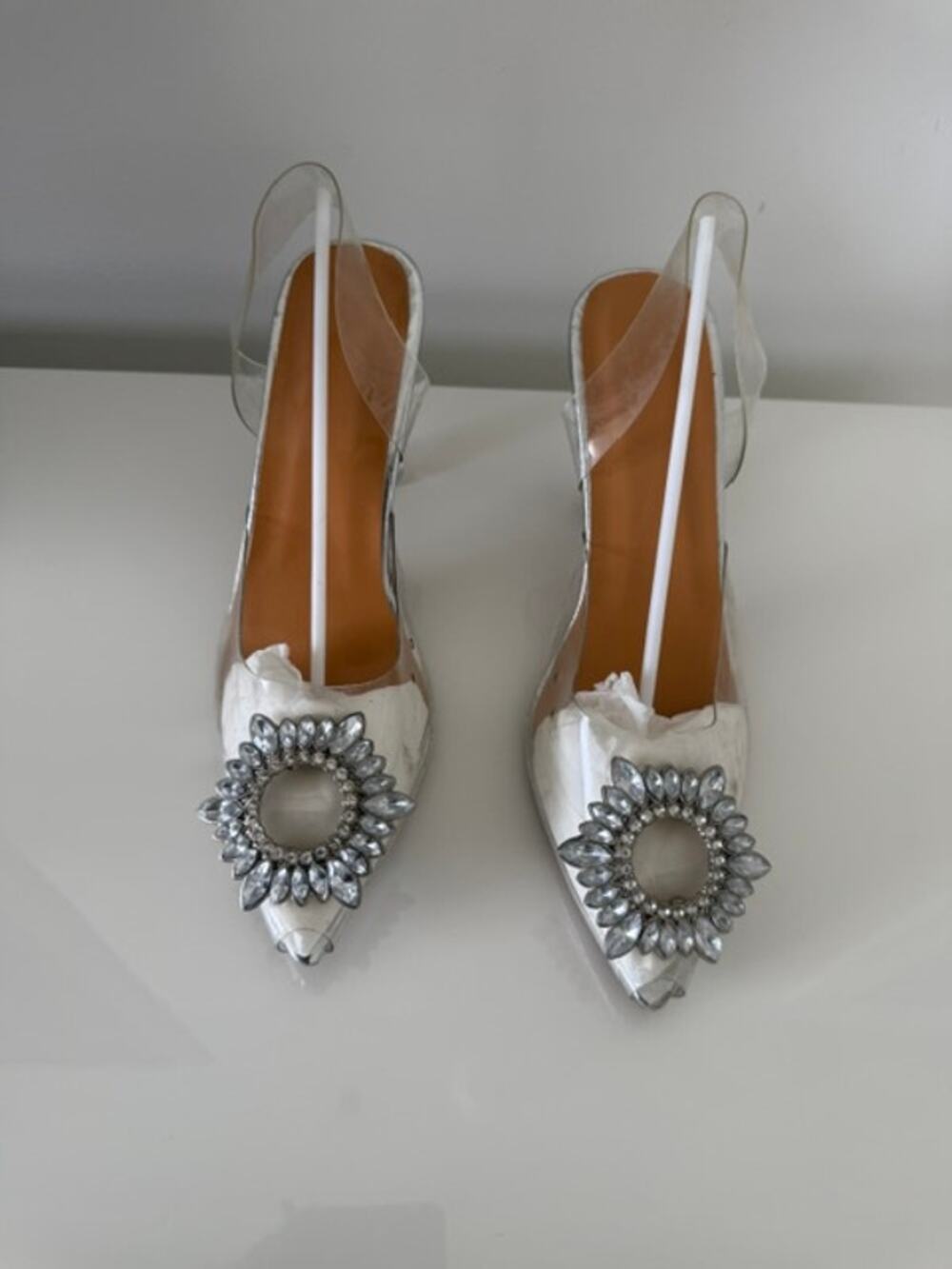 Transparent pumps feature a modern "glass slipper" aesthetic